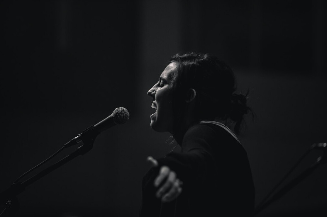 man singing on stage